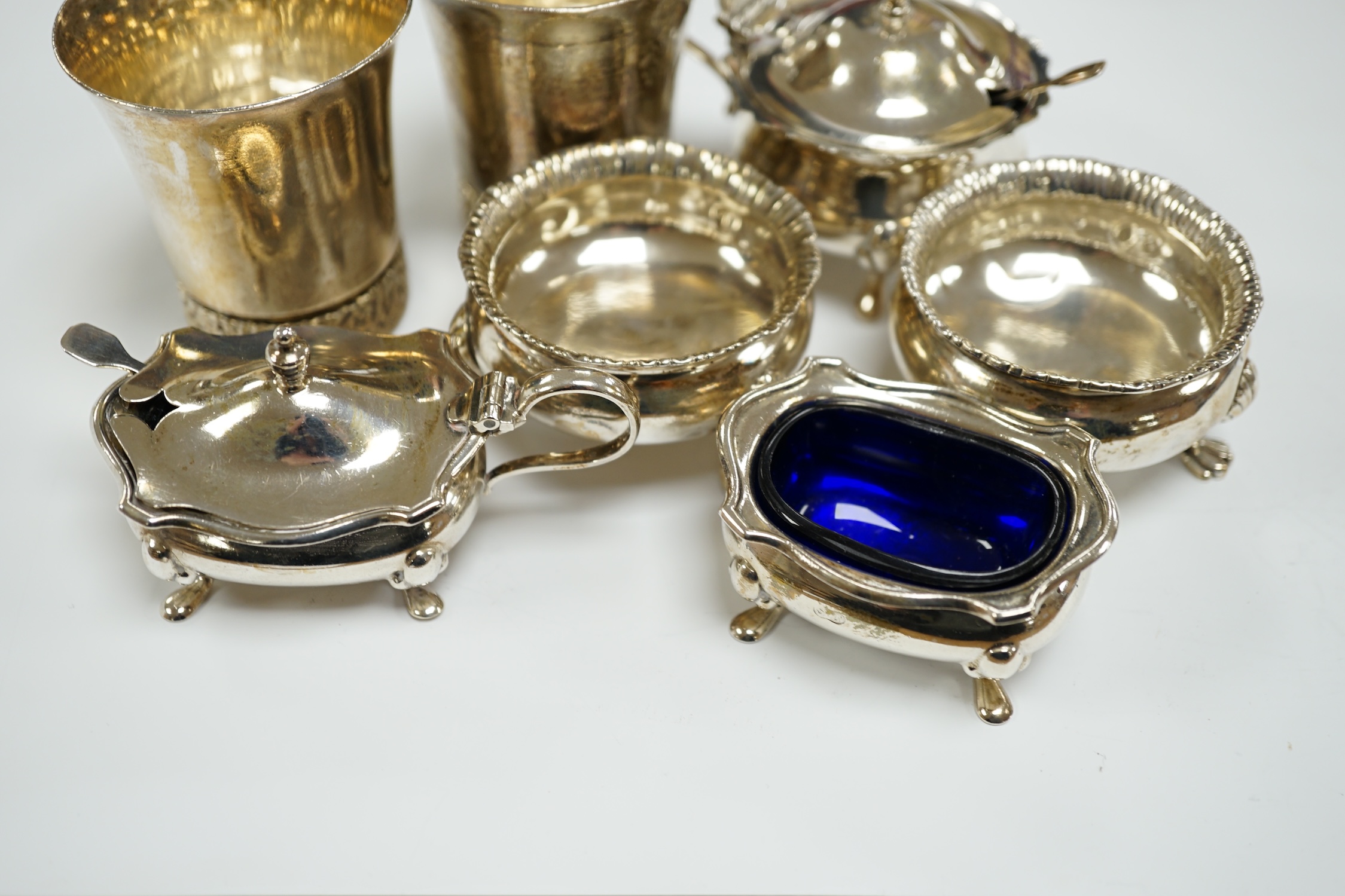 A modern pair of silver tots and five assorted silver condiments.